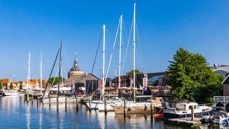 Enkhuizen, The Netherlands - July 20, 2021: Cityscape historic fishing village Enkhuizen with ships and gateway Drommedaris. in North Holland in The Netherlandsのeditorial素材