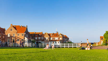 Enkhuizen, The Netherlands - July 20, 2021: People relaxing in park beside gate Drommedaris.in historic fishing village Enkhuizen North Holland in The Netherlandsのeditorial素材