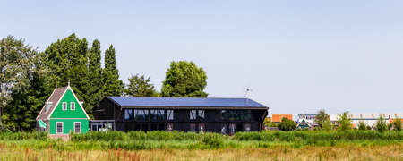 Zaanstad, The Netherlands - July 18, 2021: Panorama with traditional dutch house and musuem building in Zaanse Schans Village in Zaanstad North Holland The Netherlandsのeditorial素材