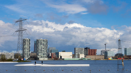 Almere, The Netherlands - April 3, 2022: Skyline Almere Stad with lake Weerwater in front in Almere, Flevoland in The Netherlands. View from parking Floriade Expo 2022.のeditorial素材