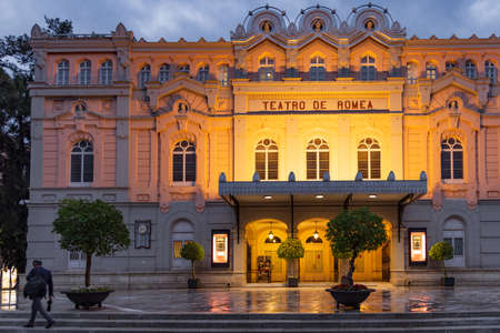 Murcia, Spain - March 30, 2022: Street scene with theater Teatro de Romea in Murcia in Spain during the evening on rainy dayのeditorial素材