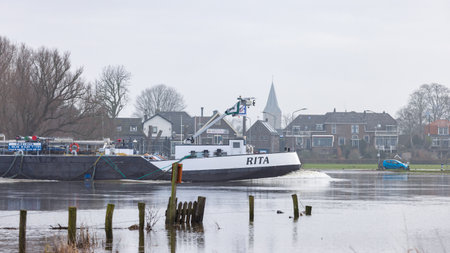Welsum, The Netherlands - January 21, 2023: Blocked cycling road caused by flooded river IJssel near Welsum in Overijssel in The Netherlandsのeditorial素材