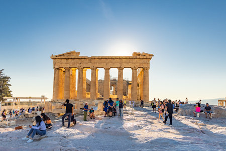 Athens, Greece: September 24, 2021: Tourist relaxing in the evening sun near Parthenon temple at Acropolis site on a sunny evening in Athens in Greeceのeditorial素材