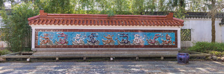 Haren, The Netherlands - April 5, 2023: Dragon tile wall in Chinese garden inspired by famous garden of Suzhou in Hortus Botanicus in Haren Municipality Groningen in Groningen province he Netherlandsのeditorial素材