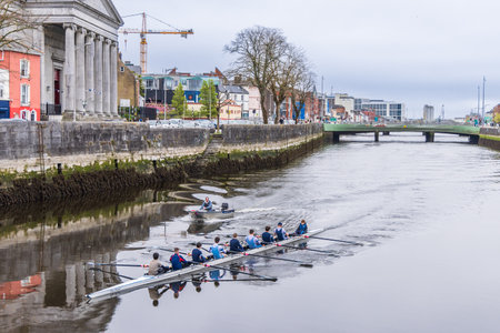 Cork, Ireland - April 16, 2023: Cityscape with rowing boat in the Lee river in the center of Cork in Munster province in Ireland Europeのeditorial素材
