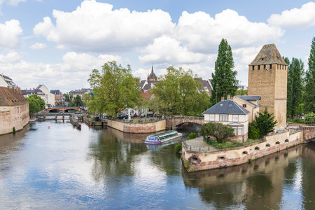 Strasbourg, France - May 14, 2023: Barrage Vauban and tourist cruise ship scenic view of Strasbourg in Elsace region along the Rhine river in Franceのeditorial素材