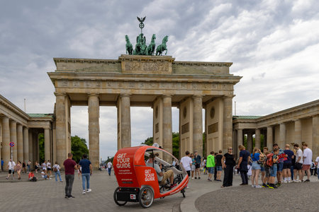 Berlin, Germany - July 24, 2023: Tour guide waiting for clients at Brandenburg gate in Berlin in Germany Europe.のeditorial素材