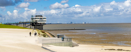 Delfzijl, The Netherlands - August 8, 2023: Viewing platform and promenade with Eemshotel along the...