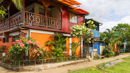 Colorful orange house and flower garden in El Castillo village along the San Juan river in Nicaragua