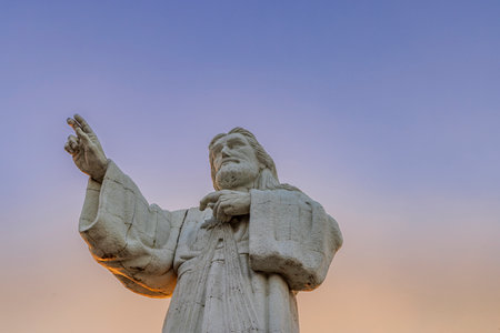 San Juan del Sur, Nicaragua - March 23, 2024: Towering contemporary Christ of the Mercy statue standing on a cliff above the bay of San Juan del Sur.のeditorial素材