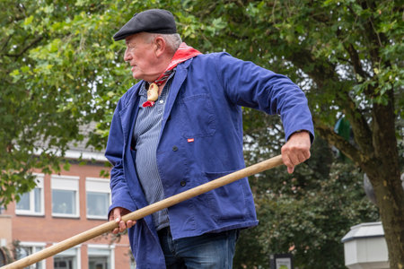 Barneveld, The Netherlands - August 1, 2024: Demonstration of harvest of grain and straw at traditional Veluwe market during the summer months in Barneveld Gelderland province in The Netherlandsのeditorial素材
