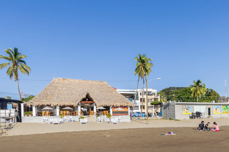 San Juan del Sur, Nicaragua - March 23, 2024: Little restaurants at the beach of San Juan del Sur coastal town on the Pacific Ocean in the Rivas department in southwest Nicaragua.のeditorial素材