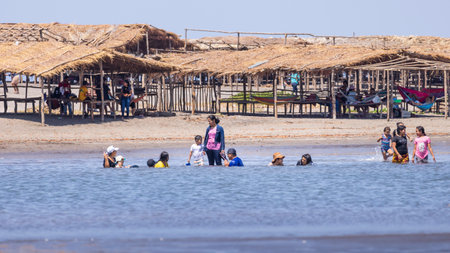 Las Penitas, Nicaragua - March 17, 2024: Local family having fun at the coast of Las Penitas entrance to Juan Venado island nature reserve in Nicaragua Central Americaのeditorial素材