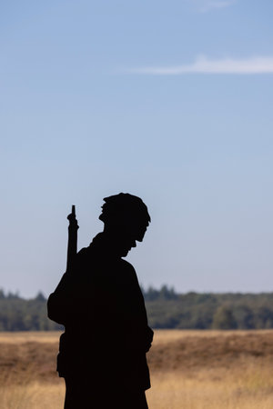 Silhouette of a soldier at Yearly event Market Garden paradroppings in september at Ginkel heath in...