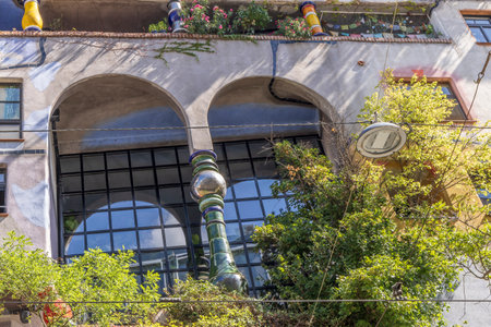 Hundertwasser house covered with trees, busches and climbing plants in Vienna in Austriaの写真素材