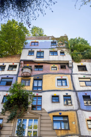 Trees growing on top of Hundertwasser village house in Vienna in Austriaの写真素材