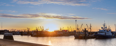 Sunset landscape of Dutch harbor Lauwersoog with fishing ships long the Waddensea in Groningen the Netherlandsの写真素材