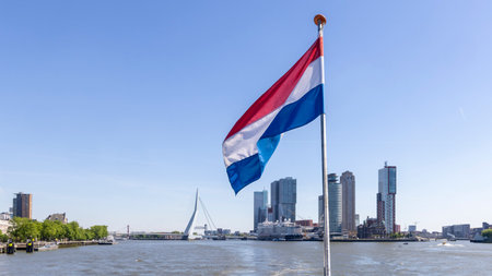 View with Dutch flag from cruise ship of Erasmus bridge and Kop van Zuid peninsula in Rotterdam The Netherlandsの写真素材