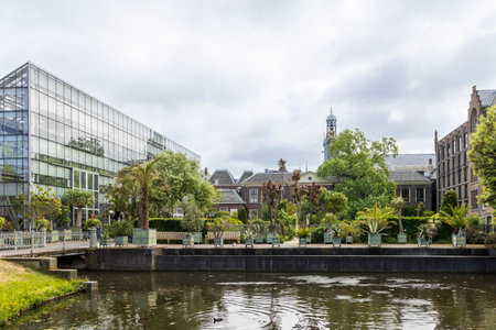 Main glass house and pond at Hortus botanicus Leiden downtown city Leiden in The Netherlandsの写真素材