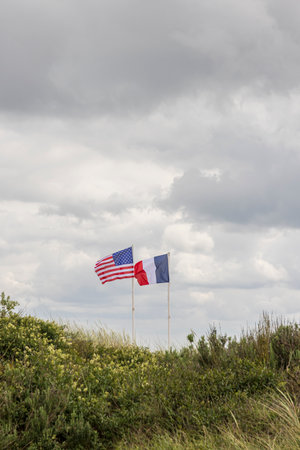 French and American flag waving at Utah beach memorial site in remembrance of American command who...