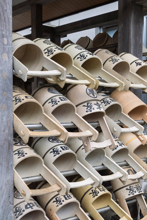 Washing buckets and fountain at temple in Yanaka subsurb in Tokyo, Japan. Yanaka is an atmospheric, traditional part of Tokyo known for its nostalgic atmosphere, temples and cats.の写真素材