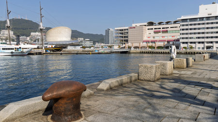 Nagasaki, Japan - March 23, 2025: Nagasaki seaside park and port with harbor terminal in the background in Dejimamachi area in Nagasaki in Japanの写真素材