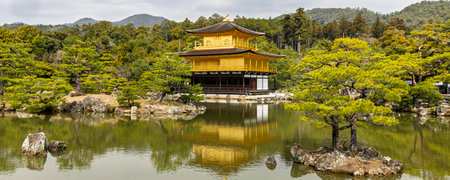 Panoramic view of Kinkakuji Temple (The Golden Pavilion) reflected in pond in Kyoto, Japanの写真素材