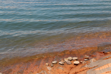 pebbles on lake Powell bank  blue near the waterの写真素材