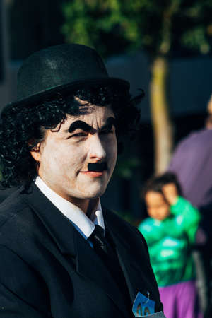 Fuengirola, Spain; Feb, 22, 2020; Man dressed as Charles Chaplin with his face painted white and mustache. Black hatのeditorial素材