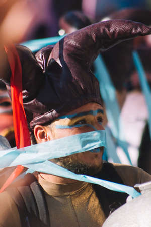 Fuengirola, Spain; Feb, 22, 2020; Man dressed as a jester with a machine that shoots blue confetti at the carnival paradeのeditorial素材