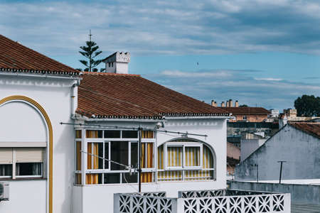 Mijas, Spain; Apr, 15, 2020; Sunset with cloudy sky over rooftops and antennas in the foreground....