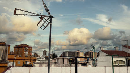 Mijas, Spain; Apr, 15, 2020; Sunset with cloudy sky over rooftops and antennas in the foreground. Home quarantine concept by COVID-19のeditorial素材