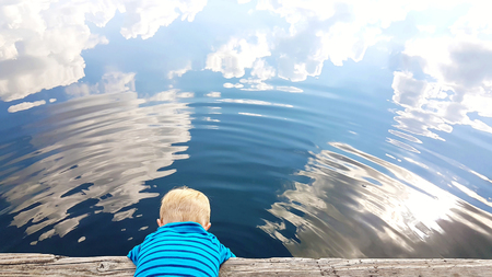 Water as a mirror for a boyの写真素材