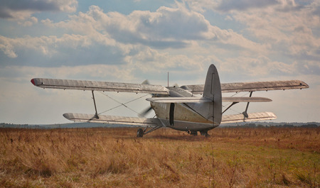 The old plane against the cloudy skyの写真素材