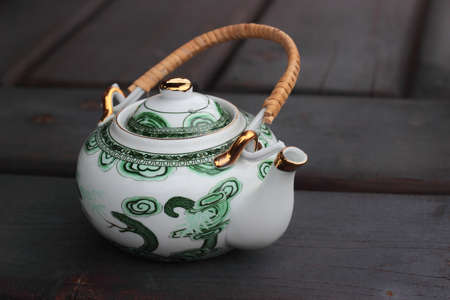 Vintage porcelain teapot on a timbered backgroundの写真素材