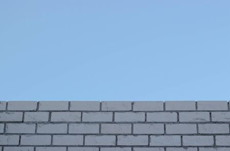 Texture of a white brick wall the blue sky backgroundsの写真素材