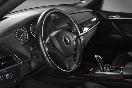 Interior of leather passenger compartment of the car in dark tones.