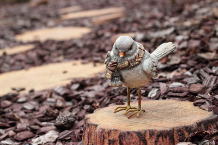 Figurines - Bird on a stub on a wooden stub backgroundの写真素材