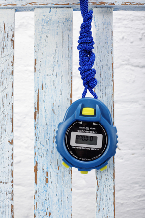 Sports equipment - Blue Digital electronic Stopwatch on a vintage wooden background