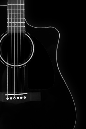 Musical instrument - Silhouette of a black acoustic guitar with cutaway on a black background.の写真素材