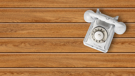 Peel white vintage phone on a wooden plank background.の写真素材