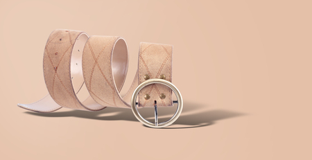 Clothes accessories - Beige leatherette belt with a buckle on a beige background.の写真素材