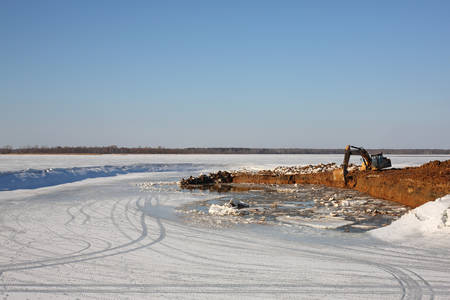 Construction of moorings for the parking of boats - Excavator behind workの写真素材
