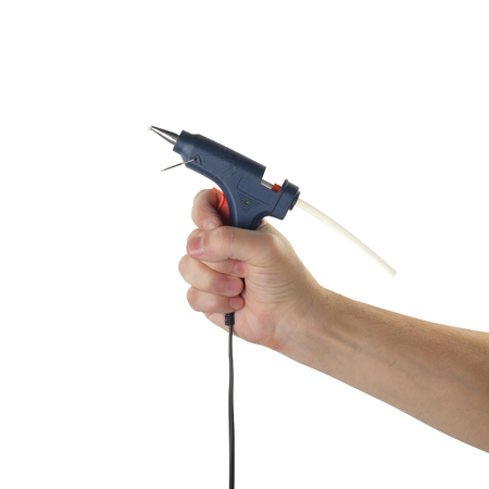 Objects tool hands action - Glue gun worker hand isolated white background.の写真素材