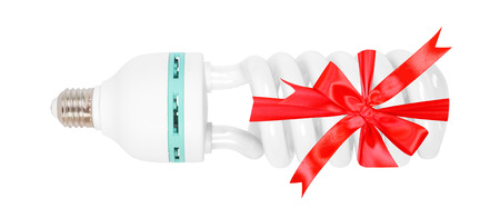 Electrical grid - Energy saving studio bulb lamp gift tied red bow on a white background. It is...