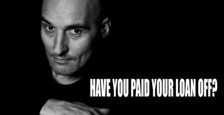 Monochrome portrait of the bald man asks on a black background: HAVE YOU PAID YOUR LOAN OFF?