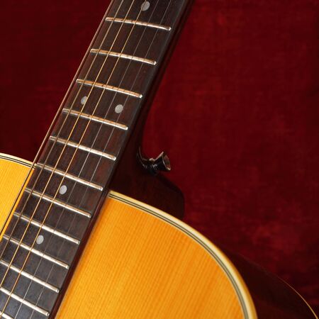 Musical instrument - Closeup fragment strings and neck vintage acoustic guitar.
