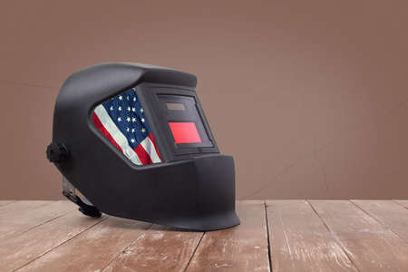 Industrial tool - USA flag Mask Welding machine on a wooden and brawn wall backgroundの写真素材