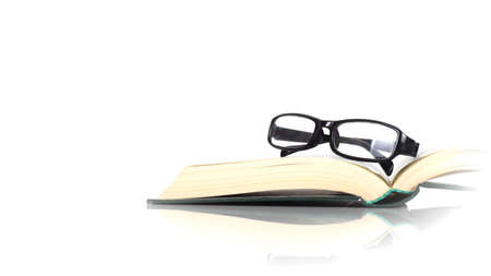 Science and education - Spectacles on the open book white background with reflectionの写真素材
