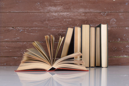 Science and education - Open book on a group books and wooden background. With reflection